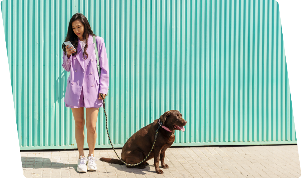 Person walking dog looking at phone